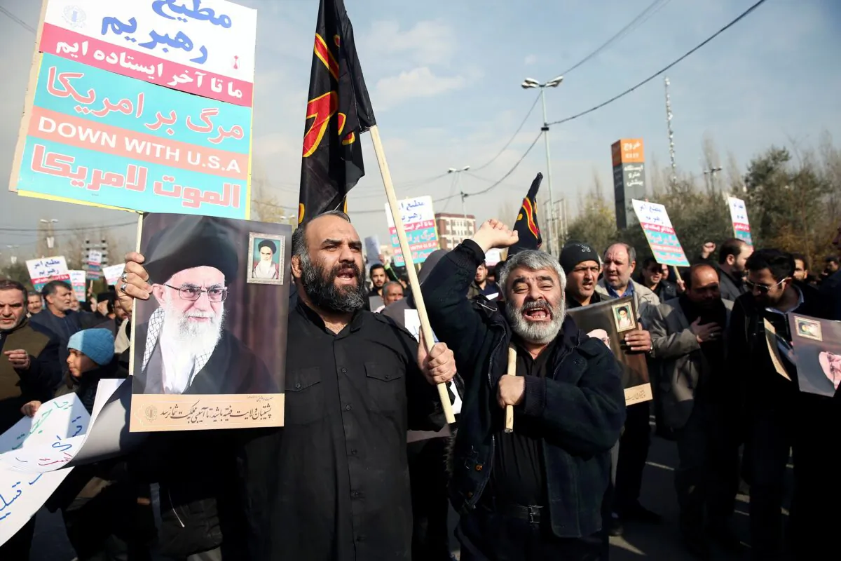 Demonstrators react during a protest against the killing of the Iranian Major-General Qassem Soleimani, head of the elite Quds Force, and Iraqi militia commander Abu Mahdi al-Muhandis who were killed in an air strike in Baghdad airport, in Tehran, Iran on Jan. 3, 2020. (Nazanin Tabatabaee/West Asia News Agency/Reuters)