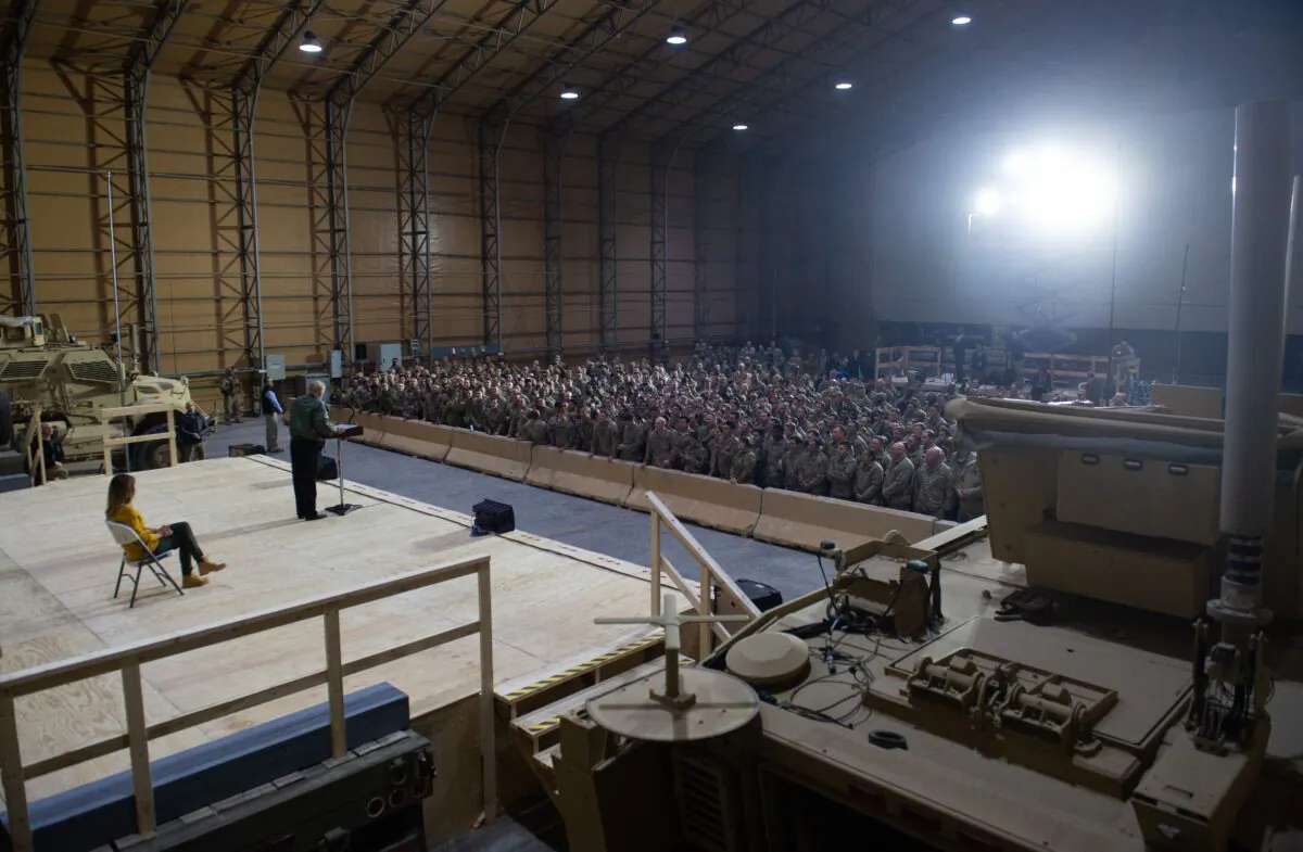 President Donald Trump speaks to members of the U.S. military as First Lady Melania Trump looks on during an unannounced trip to Al Asad Air Base in Iraq, Dec. 26, 2018. (Saul Loeb/AFP via Getty Images)
