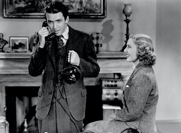 man on telephone, woman seated