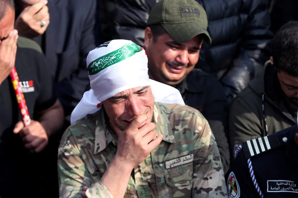 A mourner reacts as he attends the funeral of the Iranian Major-General Qassem Soleimani, top commander of the elite Quds Force of the Revolutionary Guards, and the Iraqi militia commander Abu Mahdi al-Muhandis, who were killed in an air strike at Baghdad airport, in Baghdad, Iraq, on Jan. 4, 2020. (Thaier al-Sudani/Reuters)