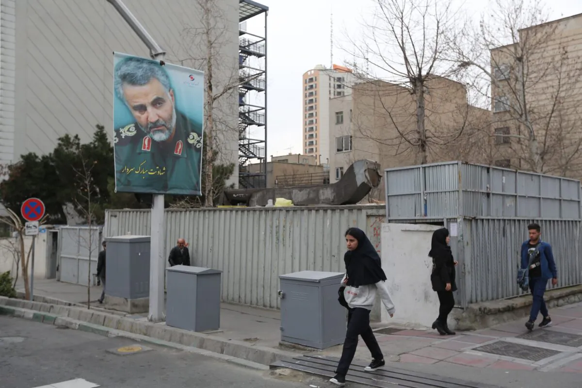 Pedestrians walk past a portrait of slain Iranian military commander Qasem Soleimani on a main road in the Iranian capital Tehran on Jan. 4, 2020. (Atta Kenare/AFP via Getty Images)