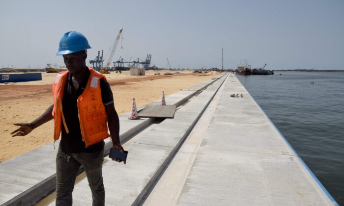 A technician works on the construction site of a new container terminal at the port of Abidjan on March 27, 2019. The modernization of Abidjan Port which started in 2012 are led by Chinese engineers and workers whose country finances up to 1,100 billion FCFA (1.67 billion euros). (Issouf Sanogo /AFP via Getty Images)