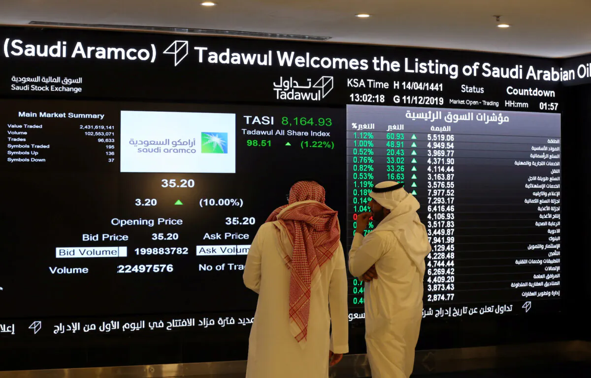 Investors monitor a screen with stock information at the Saudi Stock Exchange (Tadawul) in Riyadh, Saudi Arabia, on Dec. 11, 2019. (Ahmed Yosri/Reuters)