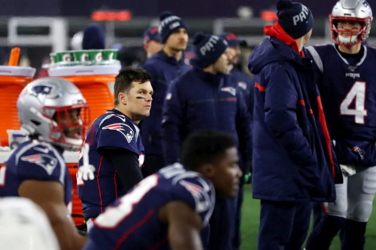 Tom Brady of the New England Patriots looks on from the bench during the fourth quarter of the AFC Wild Card Playoff game against the Tennessee Titans at Gillette Stadium in Foxborough, Mass., on Jan. 04, 2020. (Photo by Maddie Meyer/Getty Images)