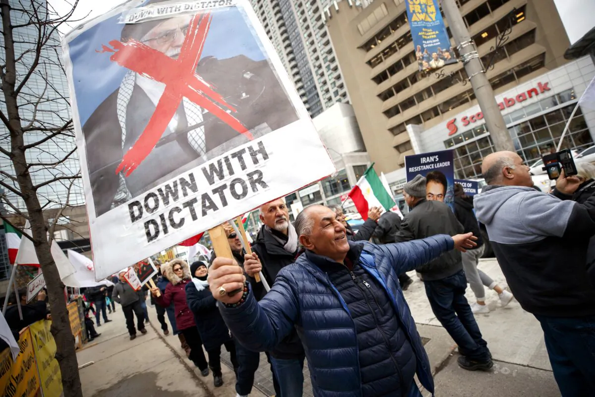 A few dozen Iranian-Canadians gather in Toronto on Jan. 3, 2020, to celebrate the death of Iranian general Gen. Canada is closely monitoring developments after Iraq's parliament called for the expulsion of foreign troops from the country, a spokesman for Defence Minister Harjit Sajjan said. (The Canadian Press/Cole Burston)