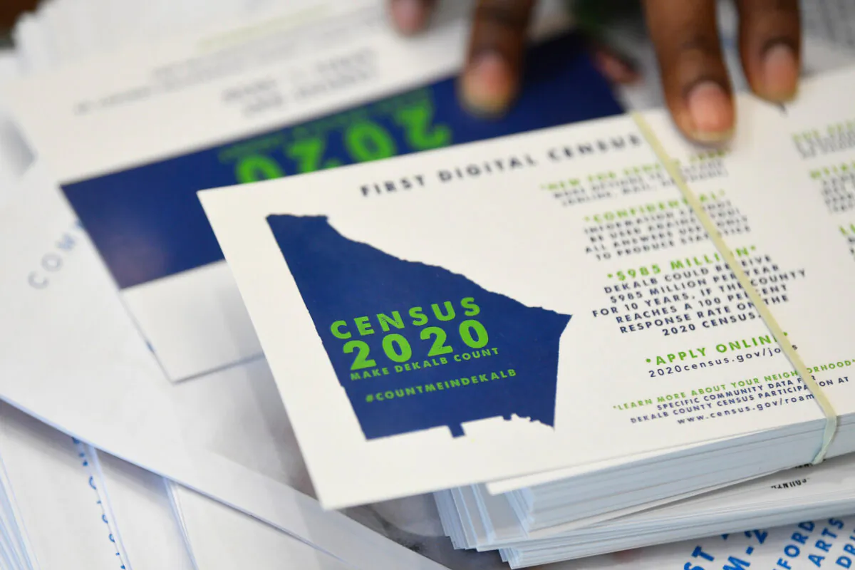 A worker gets ready to pass out instructions in how fill out the 2020 census during a town hall meeting in Lithonia, Ga., on Aug. 13, 2019. (John Amis/AP Photo)