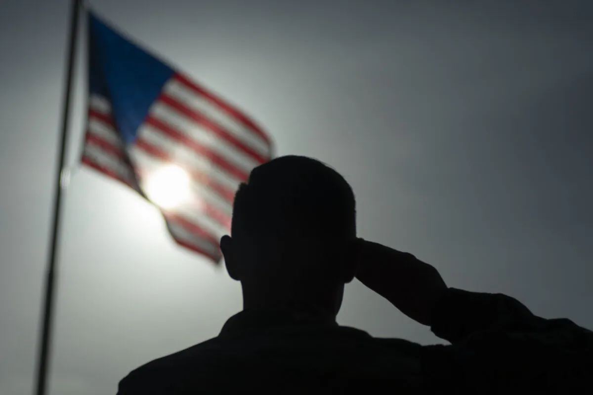 A soldier salutes the American flag. (Staff Sgt. Lexie West/U.S. Air Force via AP)