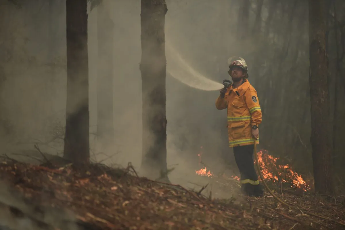 A firefighter tackles a bushfire south of Nowra, Australia, on Jan. 5, 2020. (PETER PARKS/AFP via Getty Images)