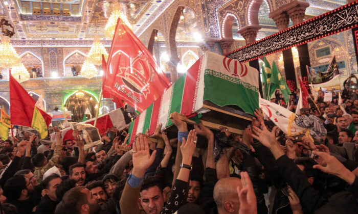 Mourners carry the coffins of slain Iraqi paramilitary chief Abu Mahdi al-Muhandis, Iranian military commander Qasem Soleimani and eight others inside the Shrine of Imam Hussein in the holy Iraqi city of Karbala, Iraq, during a funeral procession on Jan. 4, 2020.  Mohammed Sawaf/AFP via Getty Images
