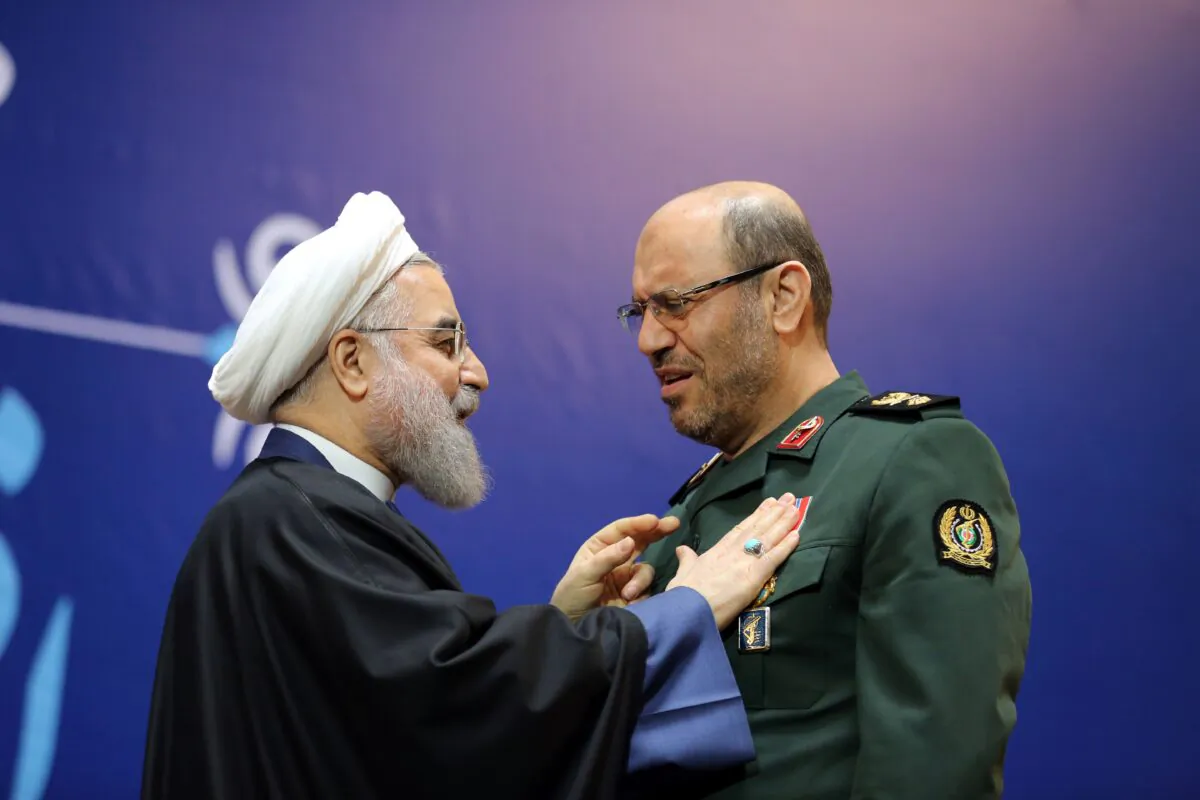 Iranian President Hassan Rouhani, left, awards Iran's defense minister, Hossein Dehghan, with the Medal of Honor for his role in the implementation of a nuclear deal with world powers, in Tehran on Feb. 8, 2016. (Atta Kenare/AFP via Getty Images)