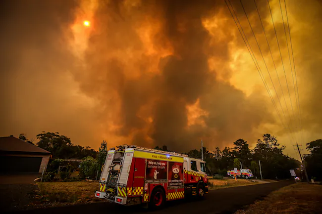 Firemen prepare as a bushfire approaches homes on the outskirts of the town of Bargo on December 21, 2019 in Sydney, Australia. (David Gray/Getty Images)