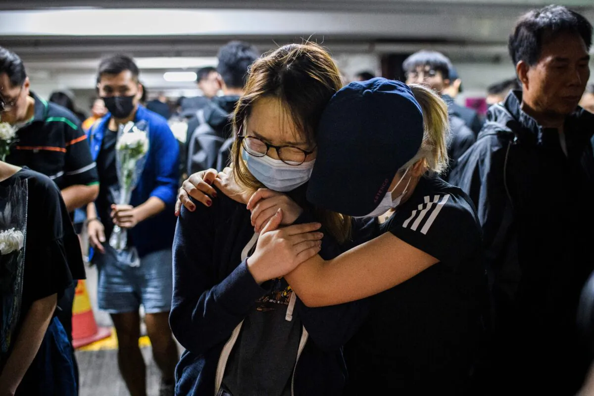 Mourner pay their respects at the car park where student Alex Chow, 22, fell during a protest in Hong Kong on Nov. 8, 2019. (Anthony Wallace/AFP via Getty Images)