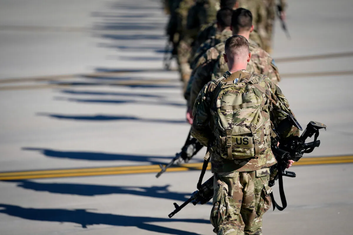 Army paratroopers assigned to the 1st Brigade Combat Team, 82nd Airborne Division, walk toward an awaiting aircraft prior to departing for the Middle East from Fort Bragg, N.C., on Jan. 5, 2020. (Bryan Woolston/File Photo/Reuters)