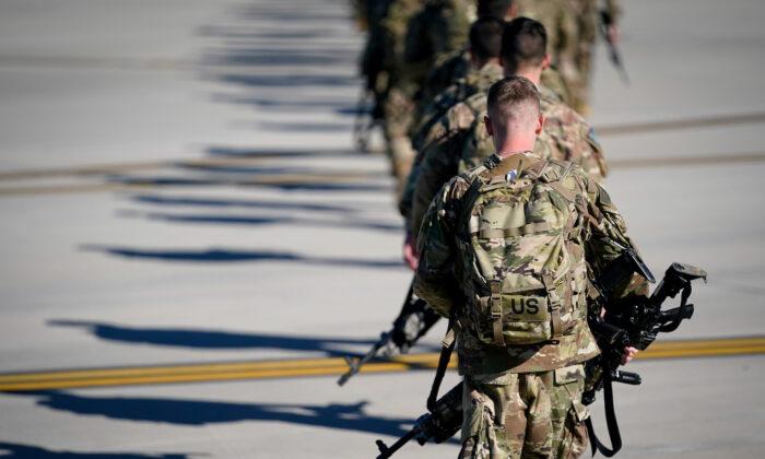 Army paratroopers assigned to the 1st Brigade Combat Team, 82nd Airborne Division, walk toward an awaiting aircraft prior to departing for the Middle East from Fort Bragg, N.C., on Jan. 5, 2020. (Bryan Woolston/File Photo/Reuters)