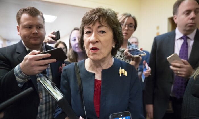 Sen. Susan Collins (R-Maine) is surrounded by reporters as she heads to vote at the Capitol in Washington on Nov. 6, 2019. (J. Scott Applewhite/AP Photo)