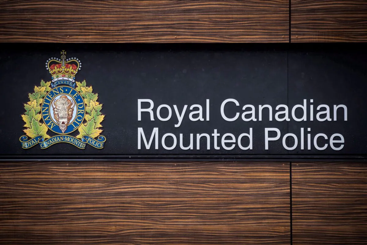 The RCMP logo is seen outside Royal Canadian Mounted Police "E" Division Headquarters, in Surrey, B.C., on Friday April 13, 2018. The assistant commissioner of the RCMP in Surrey, B.C, is warning that the city's 2020 budget will negatively affect services as well as the health and wellness of its members and support staff. THE CANADIAN PRESS/Darryl Dyck