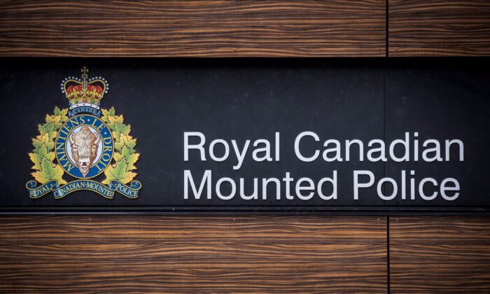 The RCMP logo is seen outside Royal Canadian Mounted Police "E" Division Headquarters, in Surrey, B.C., on Friday April 13, 2018. The assistant commissioner of the RCMP in Surrey, B.C, is warning that the city's 2020 budget will negatively affect services as well as the health and wellness of its members and support staff. THE CANADIAN PRESS/Darryl Dyck