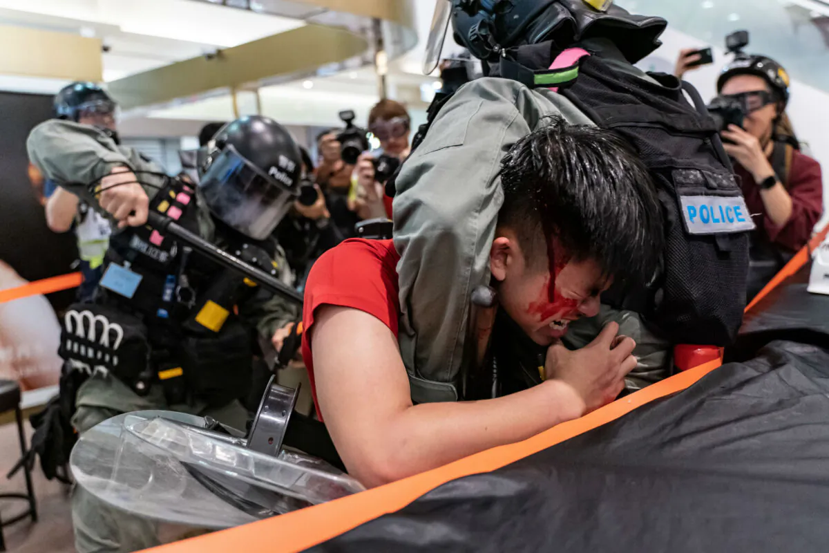 A man is detained by riot police during a demonstration in a shopping mall in Hong Kong on Dec. 28, 2019.(Photo by Anthony Kwan/Getty Images)