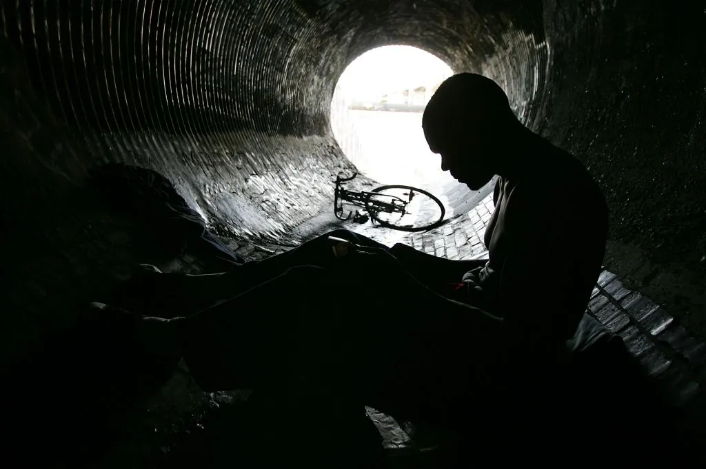 A man with drug addiction sits in an underground storm drain in Los Angeles on Jan. 18, 2006. (David McNew/Getty Images)