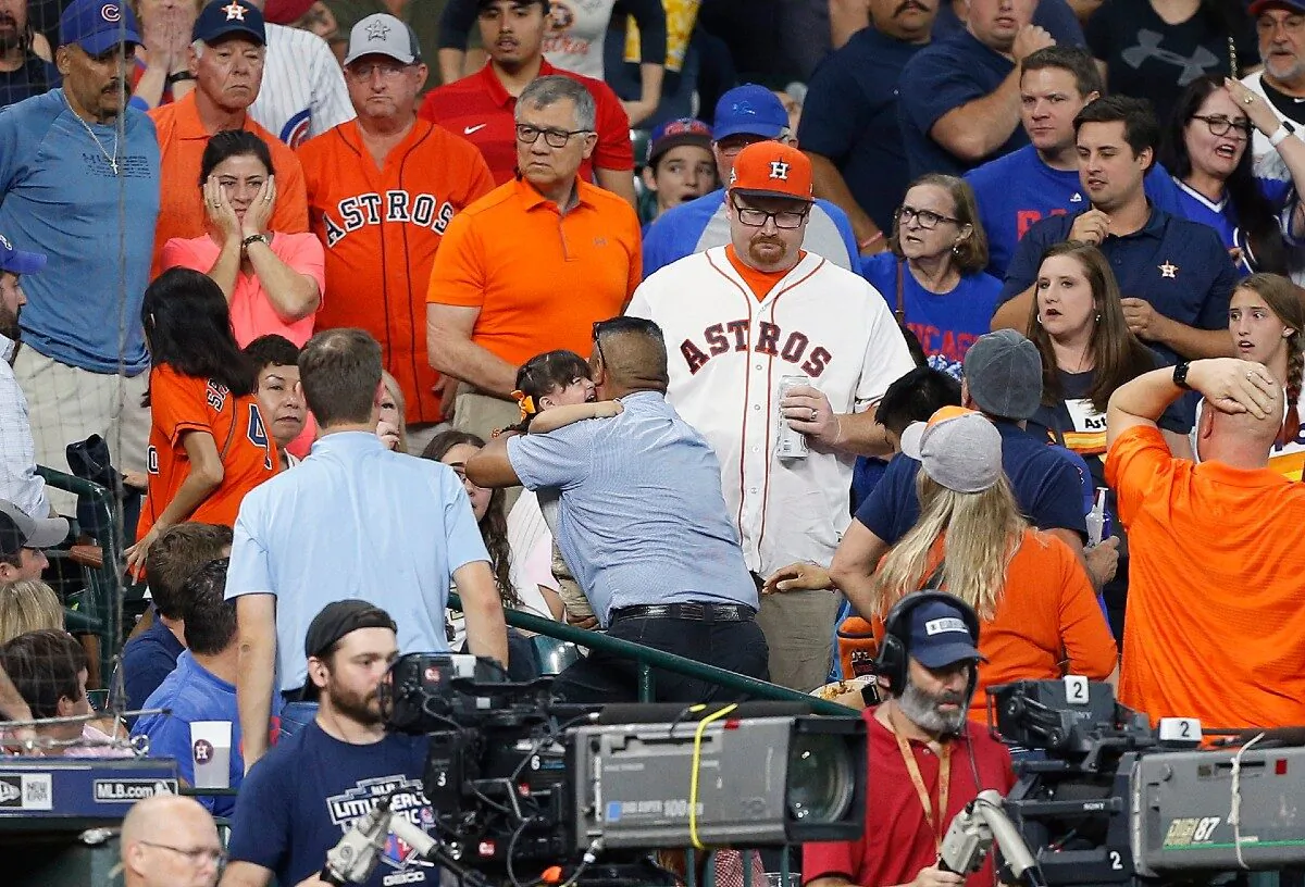A young child is rushed from the stands after being injured by a hard foul ball off the bat of Albert Almora the Chicago Cubs player in the fourth inning at Minute Maid Park in Houston, Texas, on May 29, 2019. (Bob Levey/Getty Images)