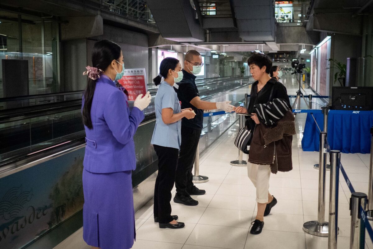 Public Health Officials hand out disease monitoring information after performing a thermal scans on passengers arriving from Wuhan, China at Suvarnabumi Airport in Bangkok, Thailand on Jan. 8, 2020. Thailand has ordered thermoscanning of passengers in four Thai airports, including Suvarnabumi, Don Mueang, Phuket and Chiang Mai. The disease surveillance and monitoring came about as a response to a pneumonia outbreak in Wuhan. (Lauren DeCicca/Getty Images)