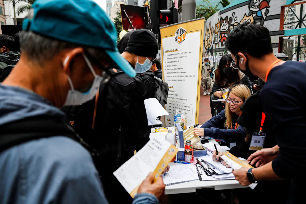 Protesters queue up at a booth of Hong Kong Construction and Engineering Employees General Union to apply for membership during pro-democracy protests on New Year's Day, to call for better governance and democratic reforms in Hong Kong, China, on Jan. 1, 2020. (Tyrone Siu/Reuters)