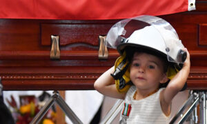 Daughter of Fallen Firefighter Dons Father's Helmet at His Funeral, Receives His Medal for Bravery