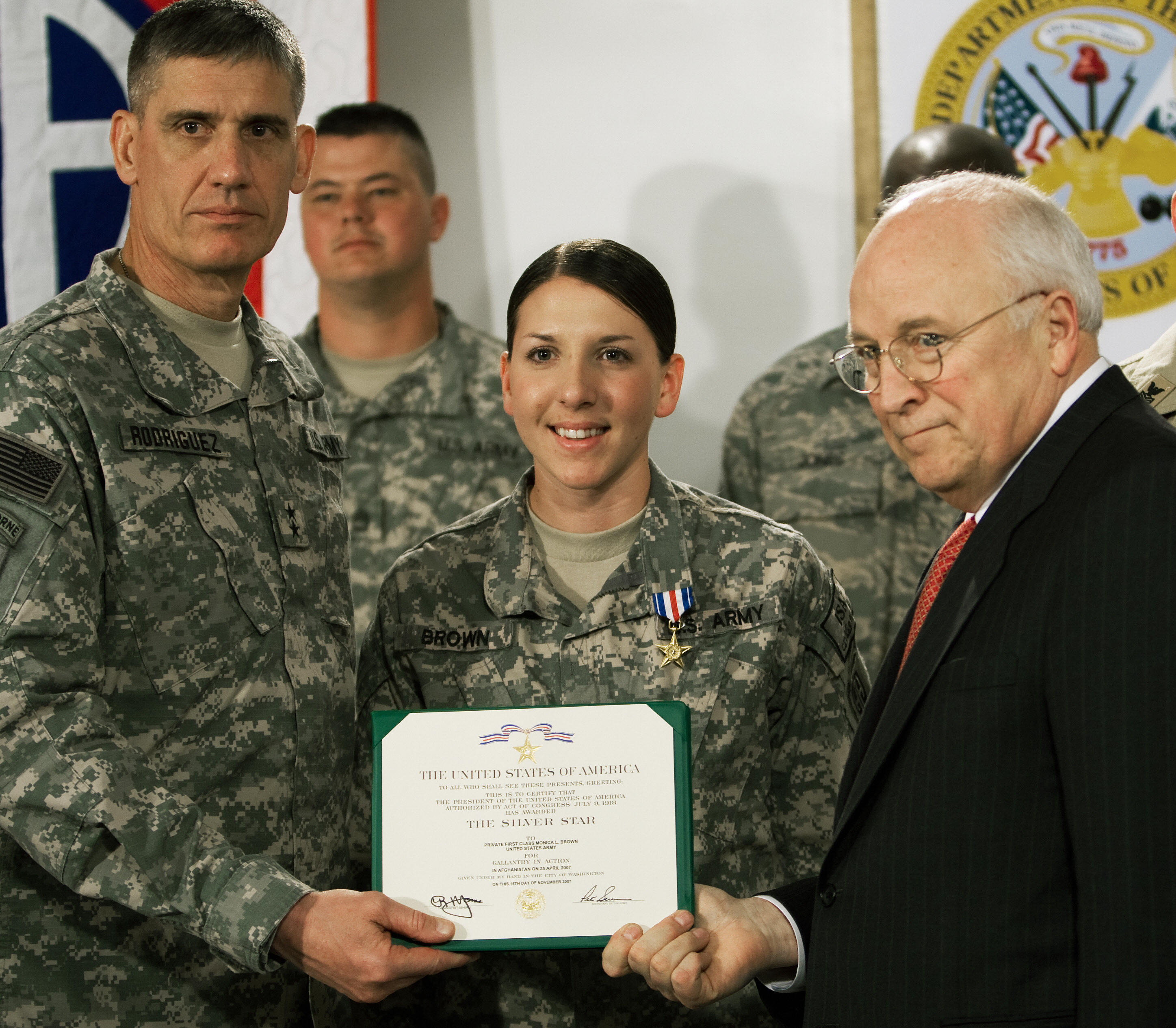 Former Vice President Dick Cheney presents Specialist Monica Lin Brown with...