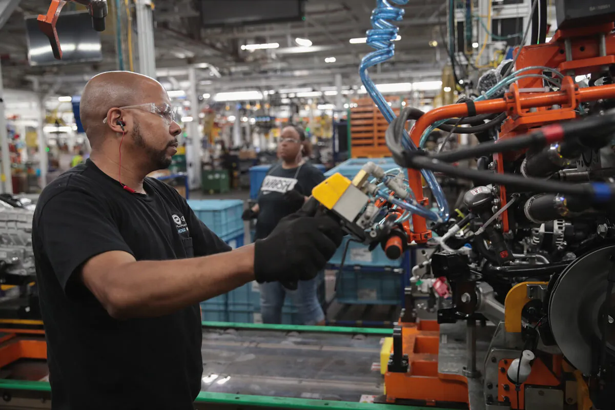 Workers assemble Ford vehicles at the company's Chicago assembly plant on June 24, 2019.   Scott Olson/Getty Images