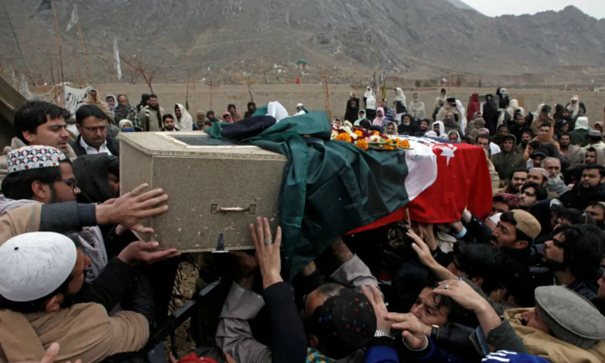 Relatives and neighbors reach out to carry the coffin of a police officer who was killed with others by a bomb blast in a mosque, during a funeral in Quetta, Pakistan on Jan. 11, 2020. (Naseer Ahmed/Reuters)