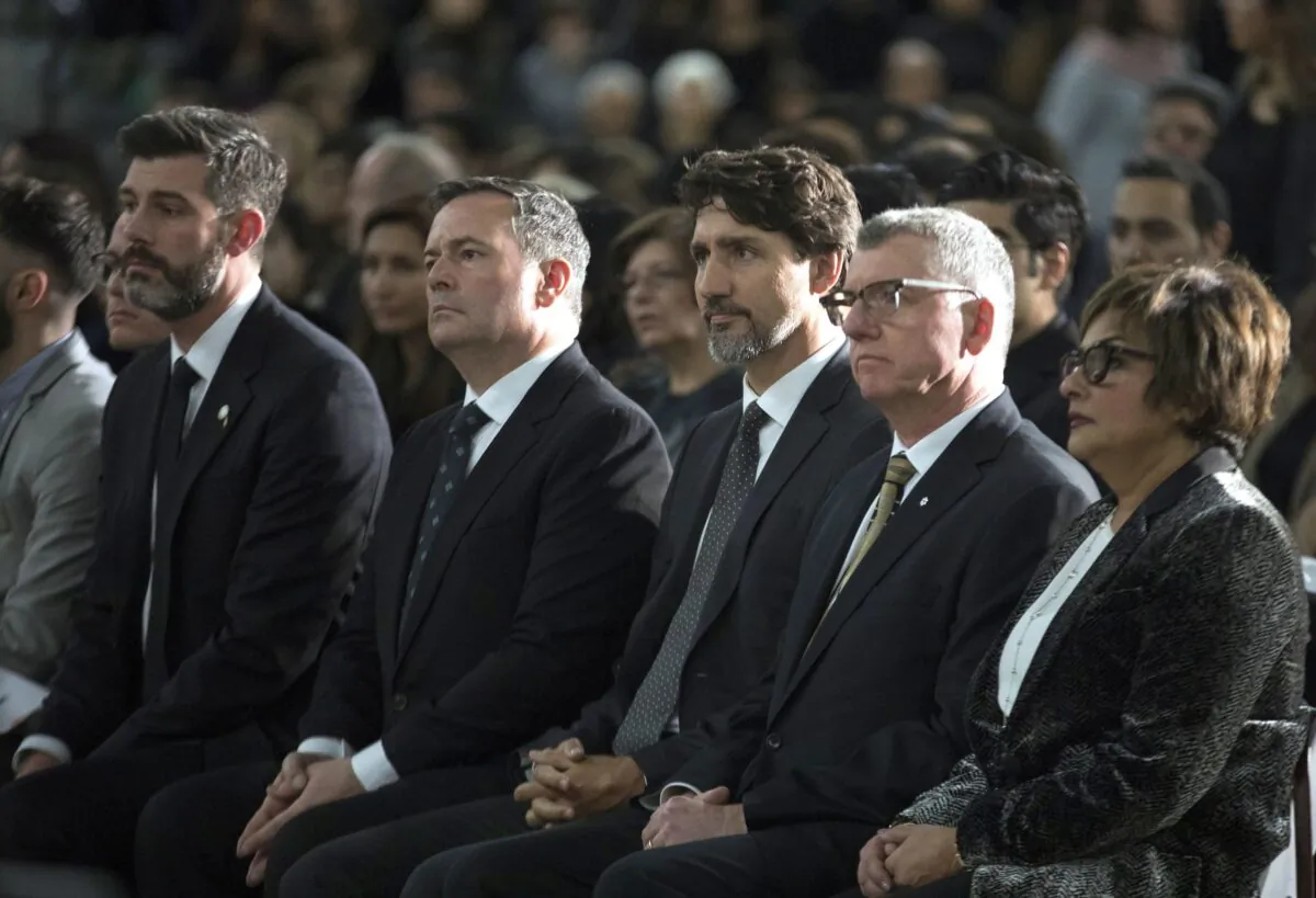 (L-R) Edmonton Mayor Don Iveson, Alberta Premier Jason Kenney, Prime Minister Justin Trudeau, and University of Alberta President David Turpin listen to speeches during a memorial for the victims of the Ukrainian plane disaster in Iran this past week, in Edmonton on Jan. 12, 2020. (The Canadian Press/Todd Korol)