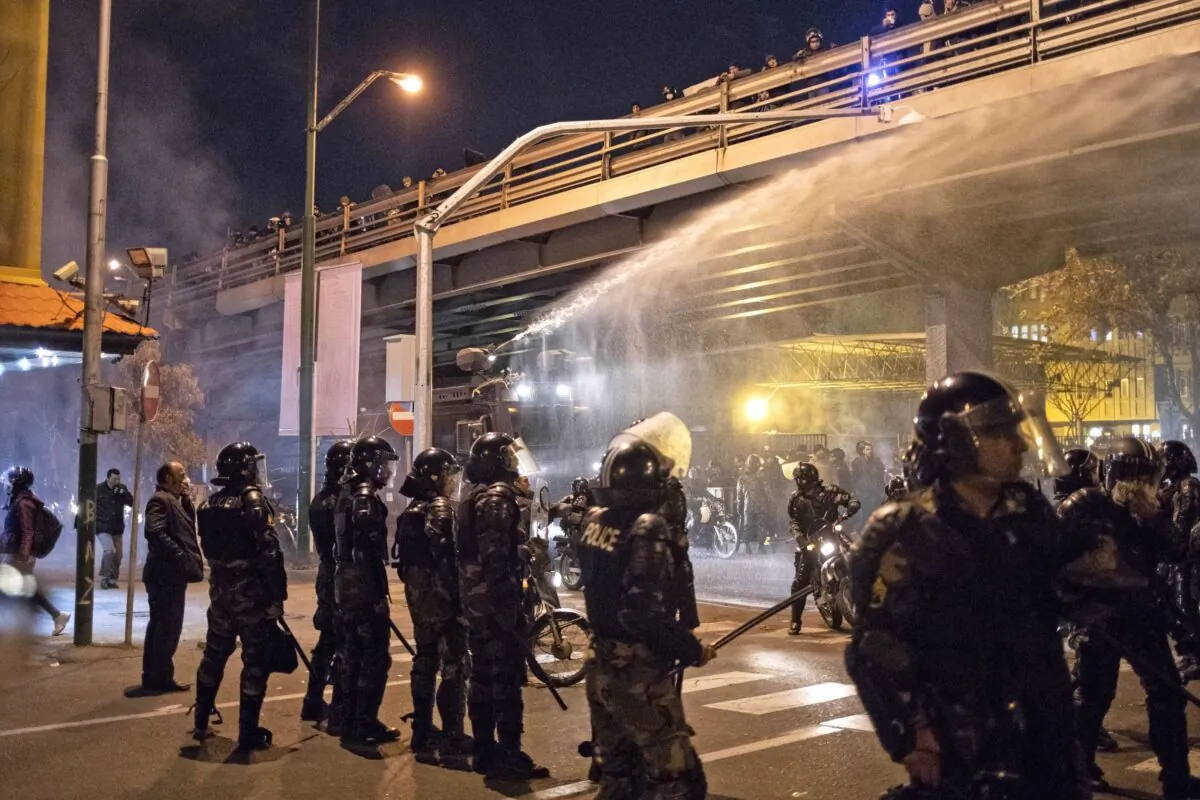Iranian riot police use a water cannon to disperse protesters during a demonstration outside Tehran's Amir Kabir University on Jan. 11, 2020. (AFP via Getty Images)