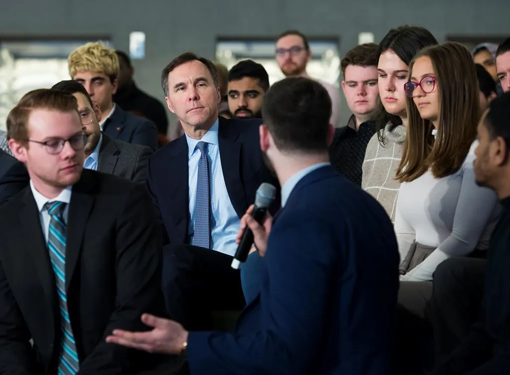 Canadian federal Finance Minister Bill Morneau (back centre) listens to a question from a Ryerson University student as he launches consultations for Budget 2020 at a town hall discussion in Toronto on Jan. 13, 2020. (The Canadian Press/Nathan Denette) 