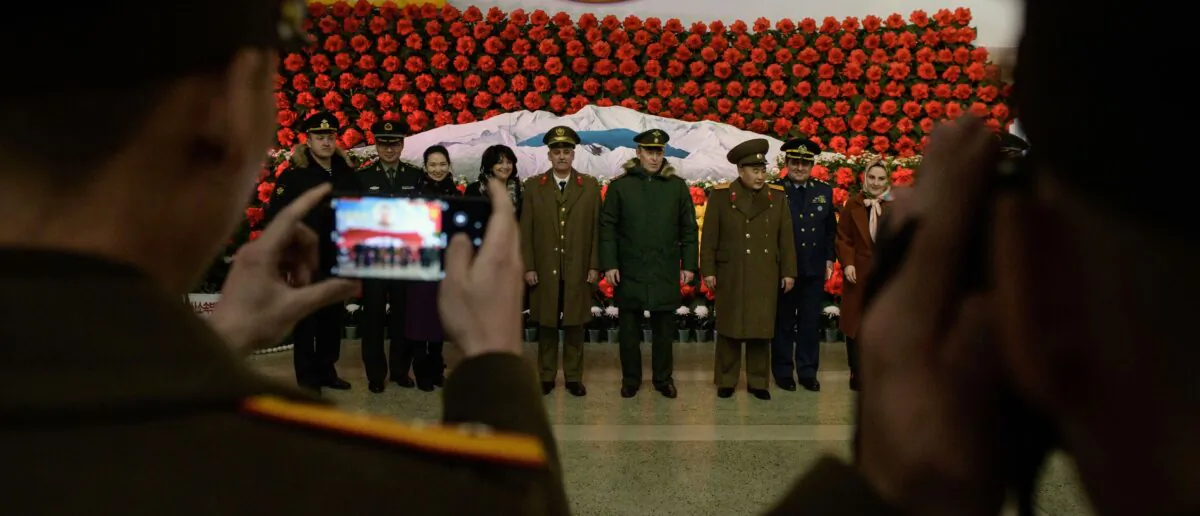 Soldiers from Russia, Iran, and China and North Korea pose for a photo before a display during a 'Kimjongilia' flower exhibition celebrating late leader Kim Jong Il, in Pyongyang, North Korea on Feb. 14, 2019. (Ed Jones/AFP via Getty Images)