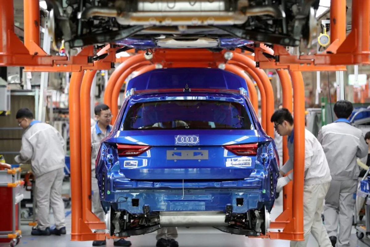 Workers work on an assembly line manufacturing Audi Q3 cars at the FAW-Volkswagen Tianjin plant in Tianjin, China on Dec. 5, 2019. (Reuters)