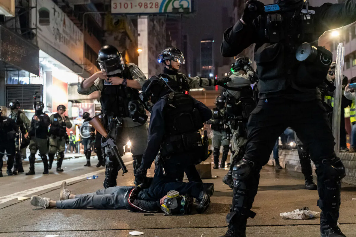 Riot police detain a protesters during a rally in Causeway Bay district on New Years Day on Jan. 1, 2020 in Hong Kong, China. (Anthony Kwan/Getty Images)