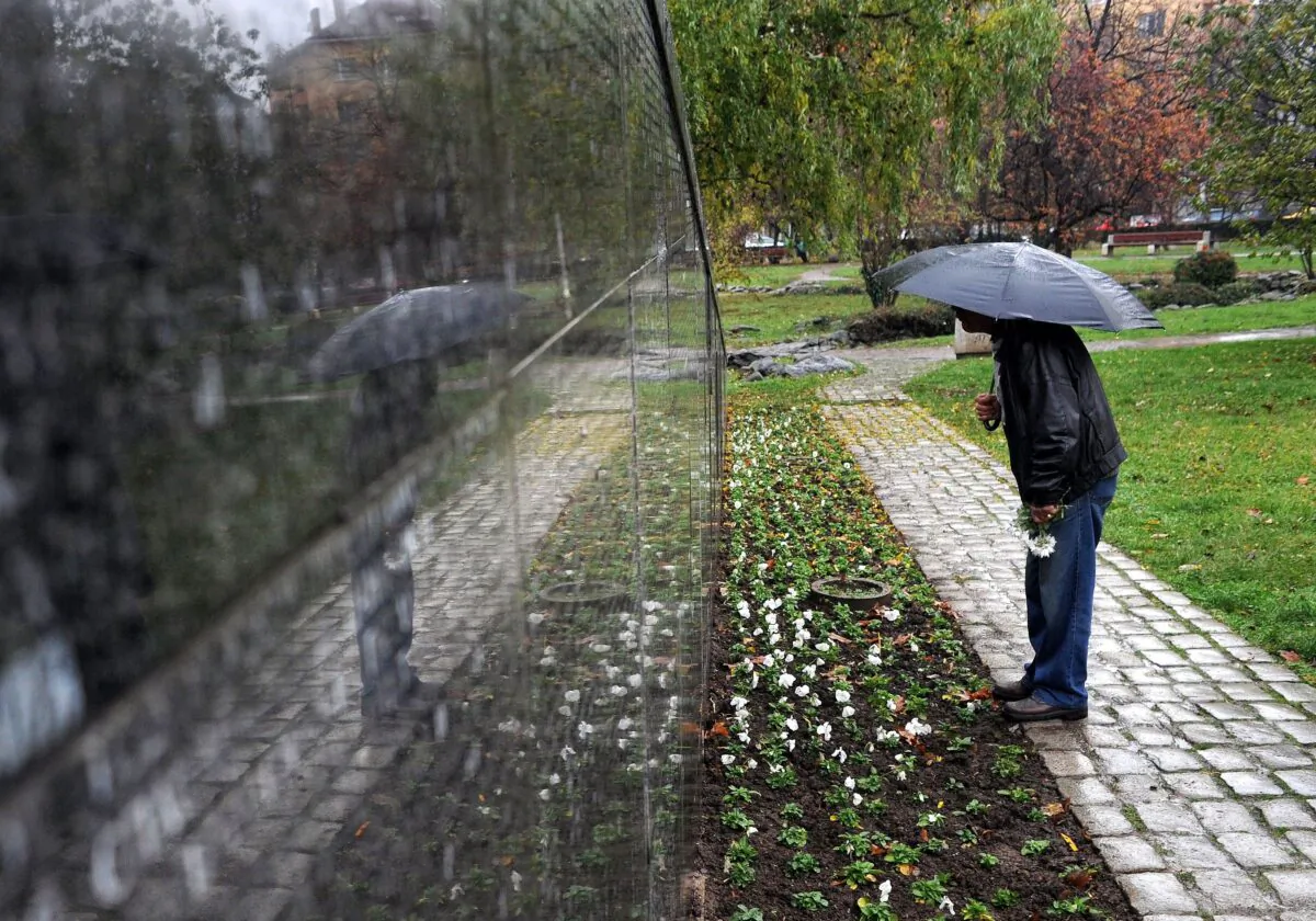 A man searches for his relatives' names on a monument with the names of some 20,000 victims of communist rule, in downtown Sofia, Bulgaria, in a file photo. (Dimitar Dilkoff/AFP via Getty Images)