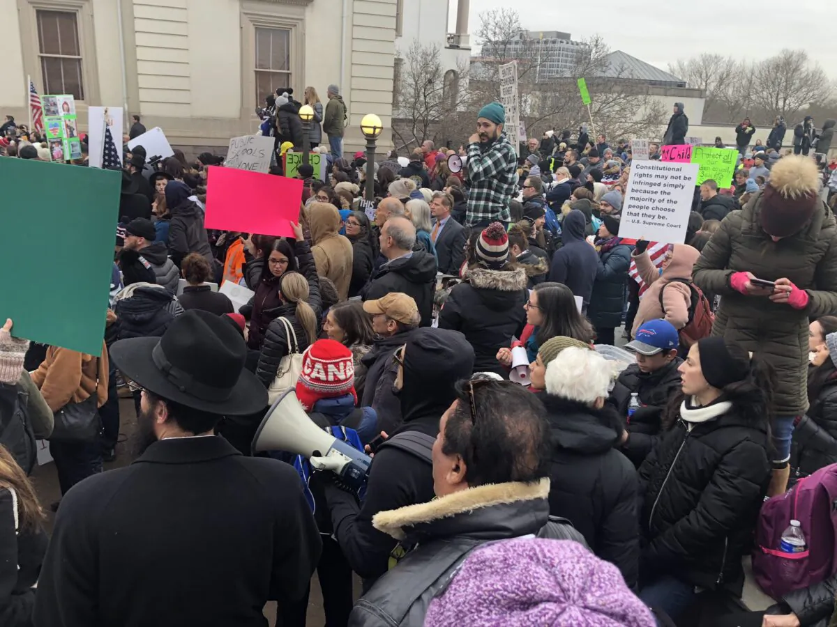 Protesters against a bill that would end religious exemptions for vaccines stand outside the New Jersey State House in Trenton, N.J. on Jan. 13, 2020. (Celia Farber/The Epoch Times)