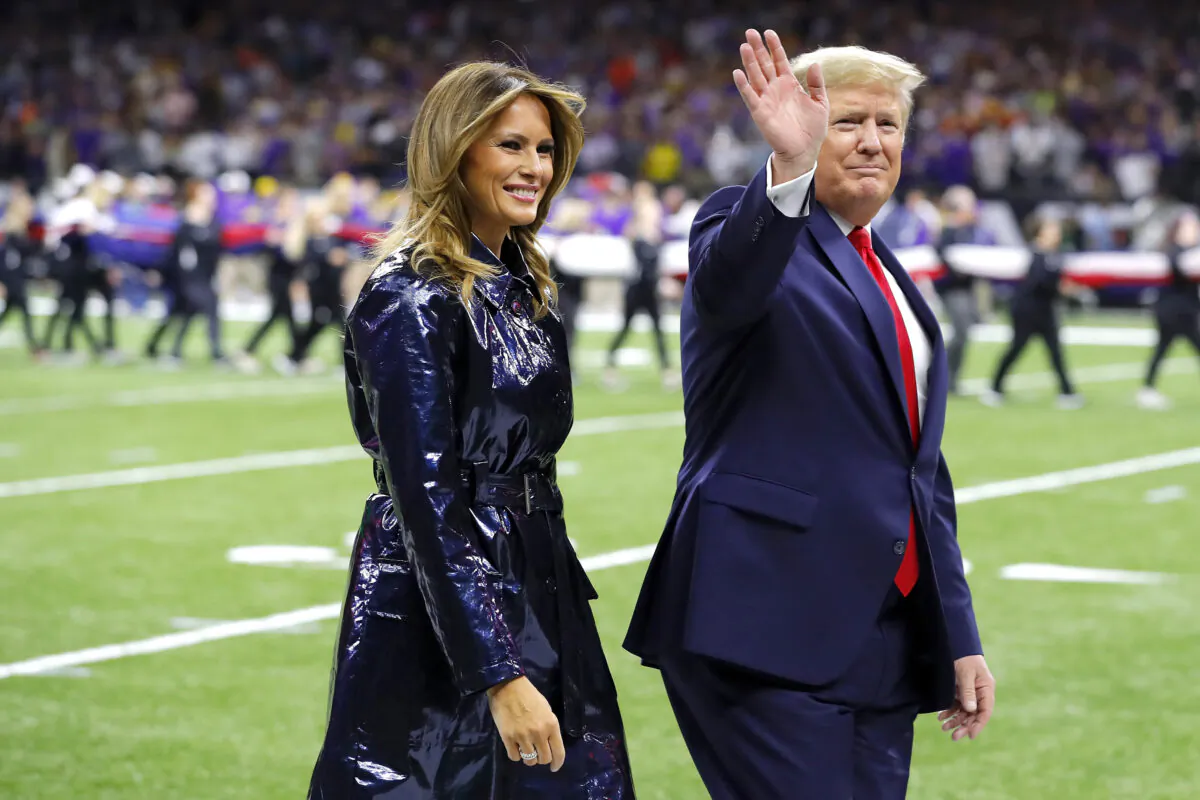 First Lady Melania Trump (L) and President Donald Trump wave prior to the College Football Playoff National Championship game between the Clemson Tigers and the LSU Tigers at Mercedes Benz Superdome in New Orleans, La., on Jan. 13, 2020. (Kevin C. Cox/Getty Images)