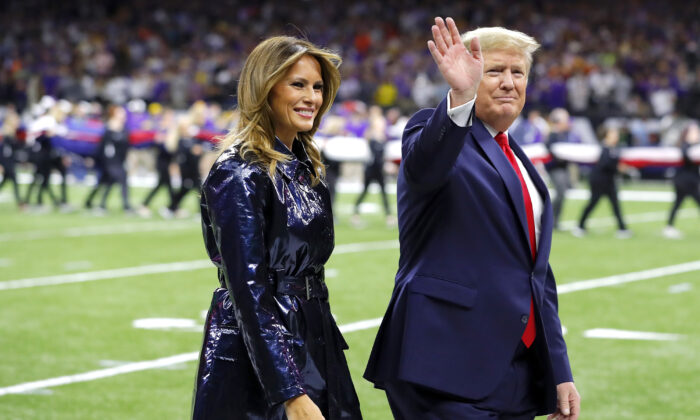 First Lady Melania Trump (L) and President Donald Trump wave prior to the College Football Playoff National Championship game between the Clemson Tigers and the LSU Tigers at Mercedes Benz Superdome in New Orleans, La., on Jan. 13, 2020. (Kevin C. Cox/Getty Images)
