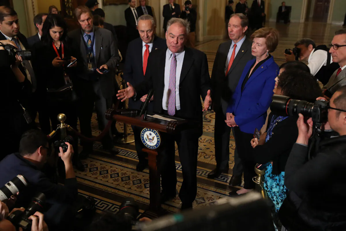 From left to right: Senate Minority Leader Chuck Schumer (D-N.Y.), Sen. Tim Kaine (D-Va.), Sen. Tom Udall (D-N.M.), and Sen. Tammy Baldwin (D-Minn.) talk to reporters following the weekly Senate Democratic policy luncheon at the U.S. Capitol in Washington on Jan. 14, 2020. (Chip Somodevilla/Getty Images)
