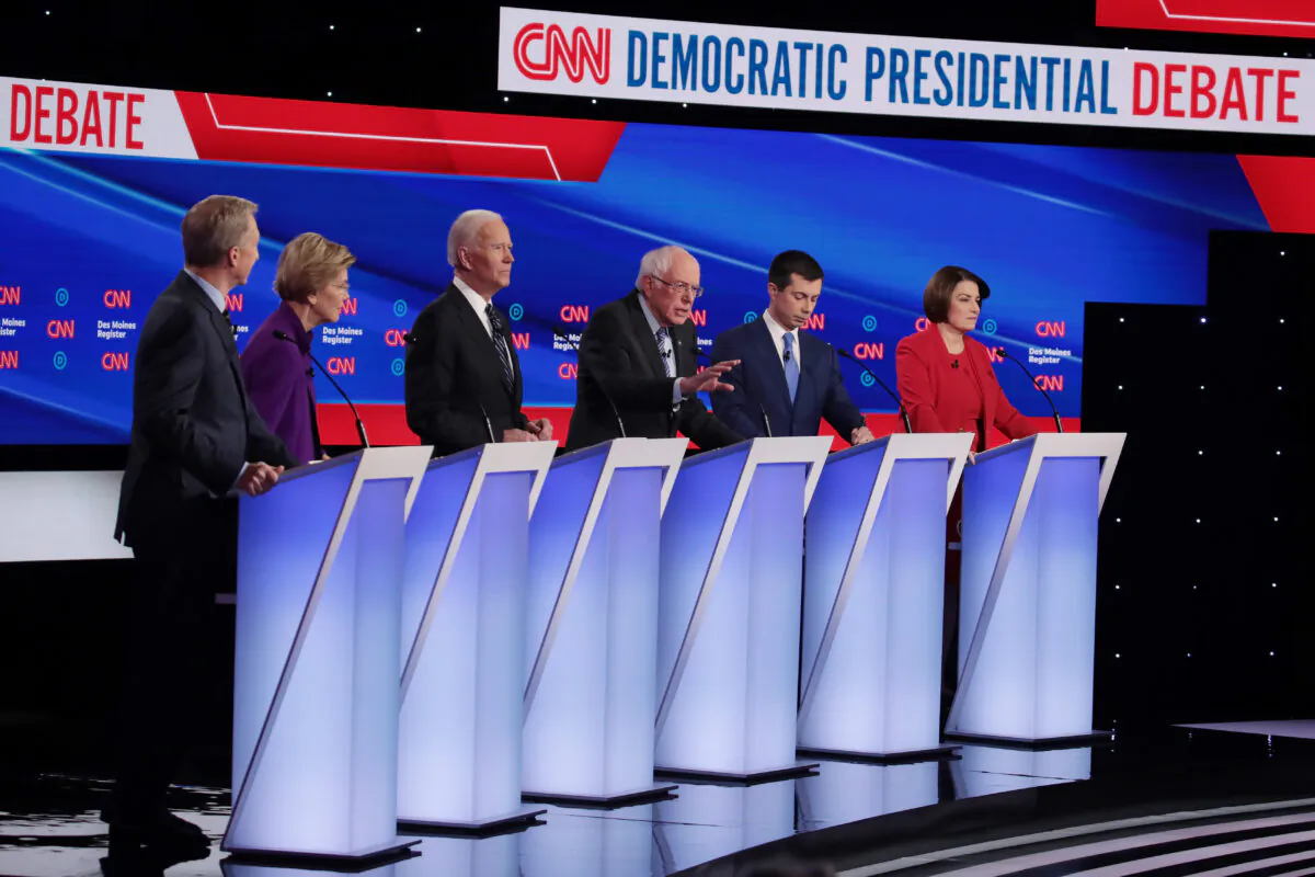 Tom Steyer (L-R), Sen. Elizabeth Warren (D-Mass.),  former Vice President Joe Biden, former South Bend, Indiana Mayor Pete Buttigieg and Sen. Amy Klobuchar (D-Minn.) listen as Sen. Bernie Sanders (I-Vt.) (3rd R)  speaks during the Democratic presidential primary debate at Drake University in Des Moines, Iowa, on Jan. 14, 2020.  (Scott Olson/Getty Images)