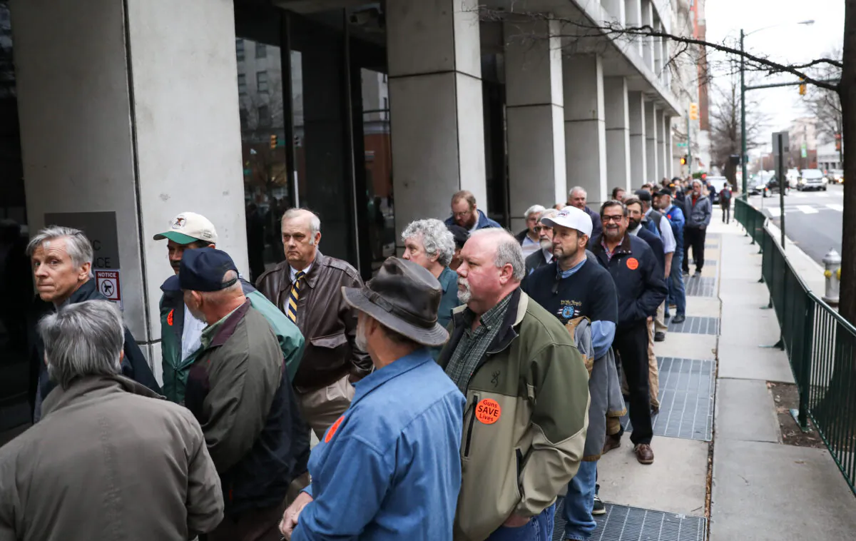 Second Amendment advocates line up to attend a hearing before four gun control bills passed the Senate Judiciary Committee at the Virginia State Capitol in Richmond, Va., on Jan. 13, 2020. (Samira Bouaou/The Epoch Times)
