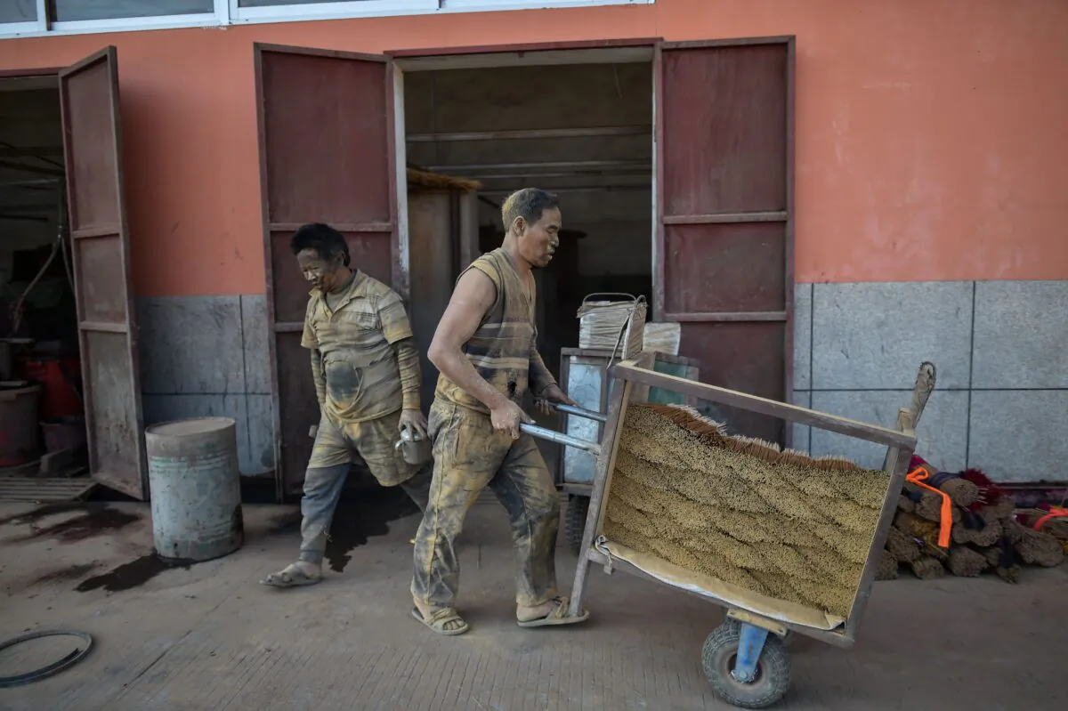 A worker is pushing a cart filled with incense sticks at the Fujian Xingquan Incense Factory in Quanzhou city of southern China's Fujian Province on December 11, 2019. (HECTOR RETAMAL/AFP via Getty Images)