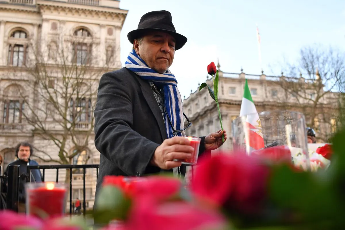 Demonstrators from the Anglo-Iranian Communities in the UK attend a vigil opposite the gates of 10 Downing Street in central London on Jan. 10, 2020, for the victims of the Ukrainian airliner which was downed by Iranian military on Jan. 8, killing all 176 onboard. (Ben Stansall/AFP via Getty Images)