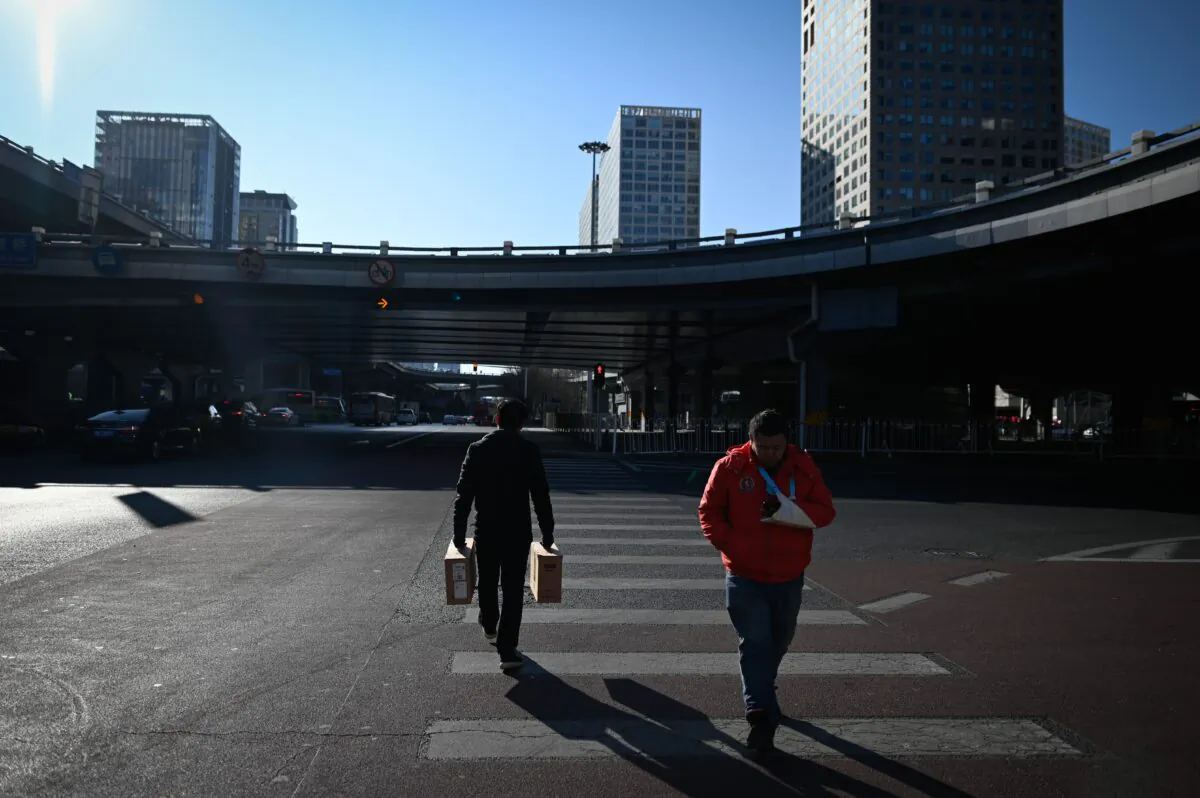 Pedestrians cross a street at a Central Business District (CBD) in Beijing on Jan. 14, 2020. (Wang Zhao/AFP via Getty Images)
