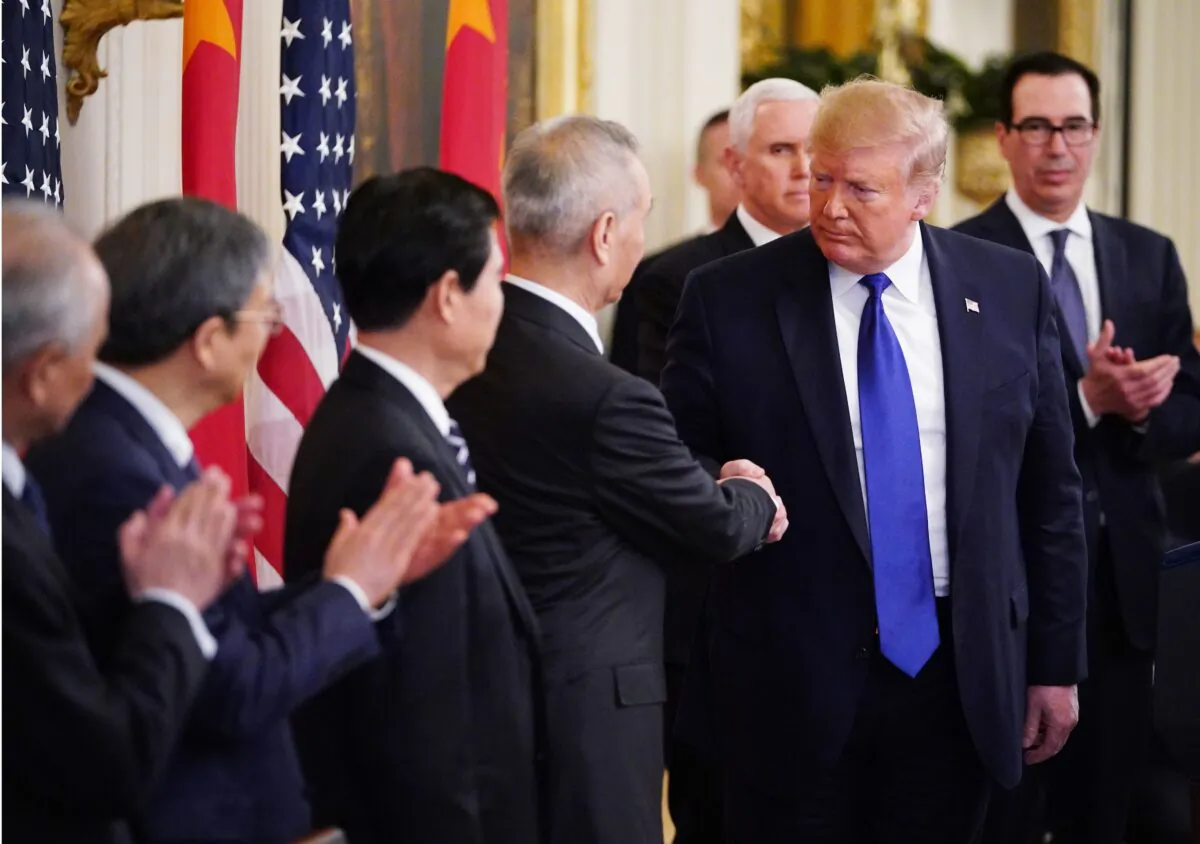 US President Donald Trump (R) and China's Vice Premier Liu He, the country's top trade negotiator, shake hands before signing a trade agreement between the US and China during a ceremony in the East Room of the White House in Washington, DC on Jan. 15, 2020. (Mandel Ngan/AFP via Getty Images)