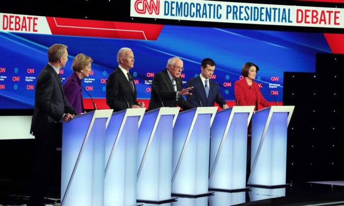 (L-R) Tom Steyer, Sen. Elizabeth Warren (D-Mass.), former Vice President Joe Biden, former South Bend, Indiana Mayor Pete Buttigieg and Sen. Amy Klobuchar (D-Minn.) listen as Sen. Bernie Sanders (I-Vt.) (3rd R) speaks during the Democratic presidential primary debate at Drake University in Des Moines, Iowa, on Jan. 14, 2020. (Scott Olson/Getty Images)
