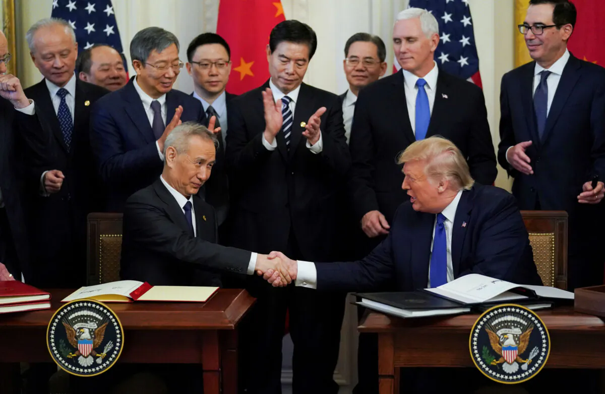 Chinese Vice Premier Liu He and U.S. President Donald Trump shake hands after signing "phase one" of the U.S.–China trade agreement during a ceremony in the East Room of the White House on Jan. 15, 2020. (Kevin Lamarque/Reuters)