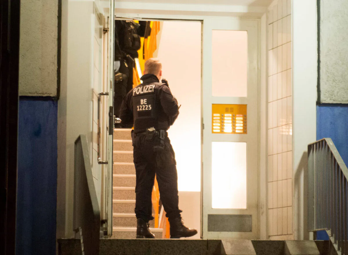 Policemen enter a residential building in Berlin's Marzahn-Hellersdorf district, where they carried out a raid, on Jan. 14, 2020. (Dennis Braetsch/DPA/AFP via Getty Images)